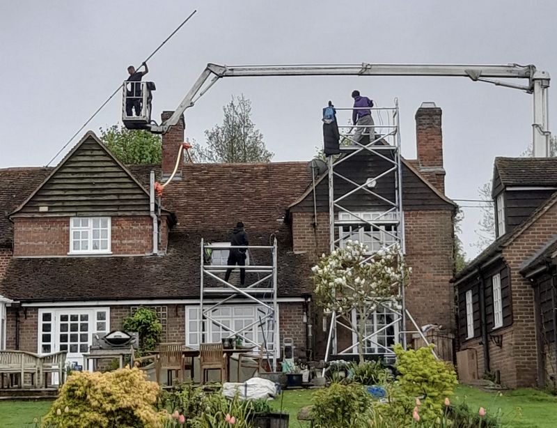 The Roof Moss Cleaners using cherry picker and scaffolding to clean roof safely and professionally in Alcester, Warwickshire
